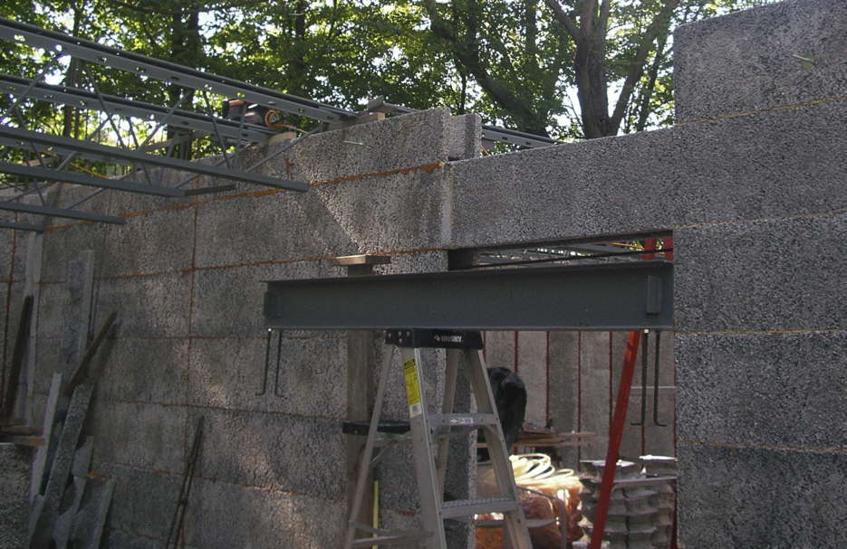 The reinforcing beam for use over the doorway of the interior wall
